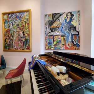 Piano with paintings on wall
