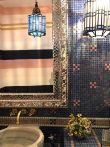 Bathroom detail of sink, mirror and blue tiles